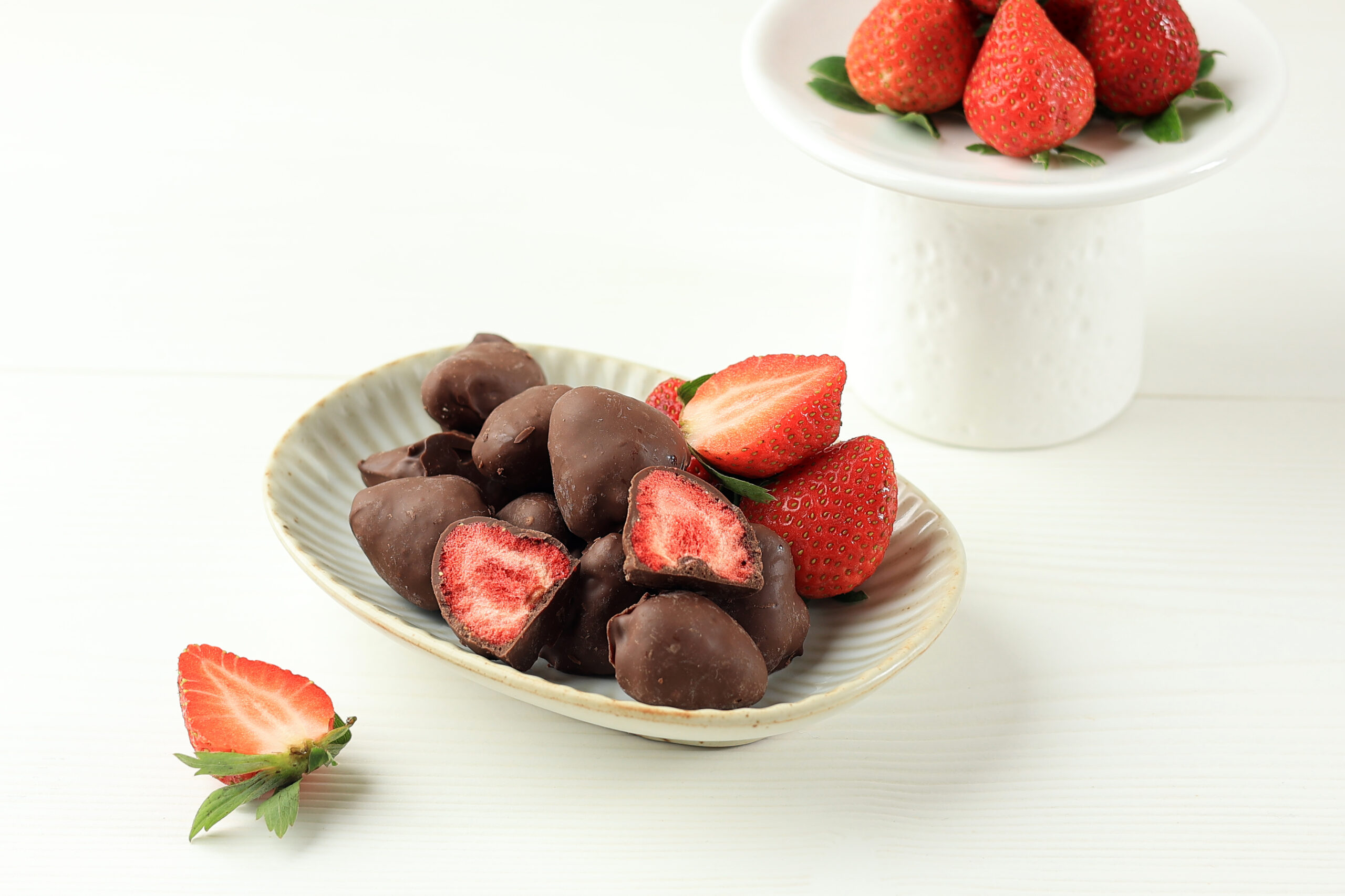 dried-strawberry-coated-with-chocolate-white-table-scaled.jpg