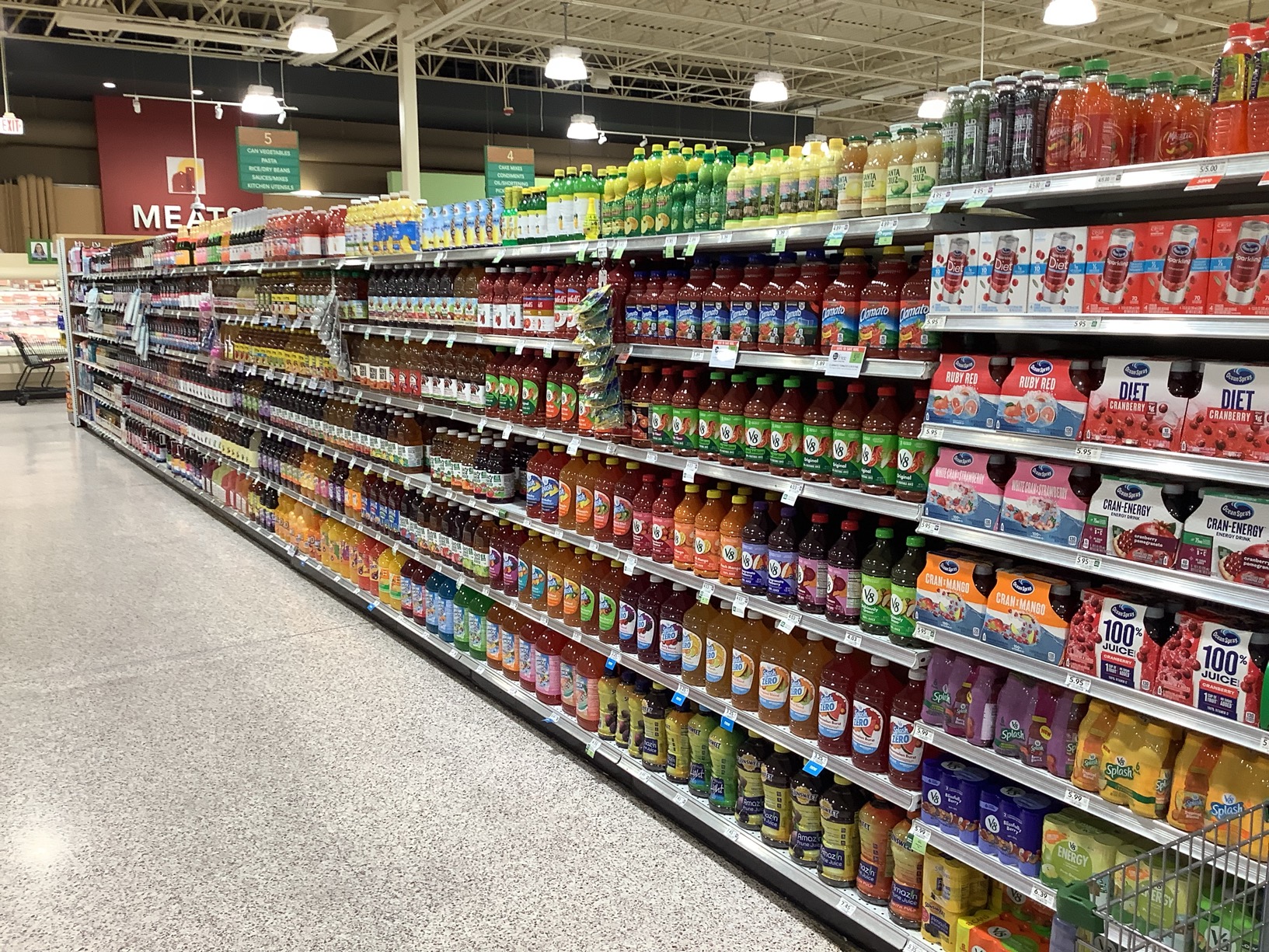 Grocery store shelf audit view of beverage category with organized products, pricing labels, and consistent planogram execution