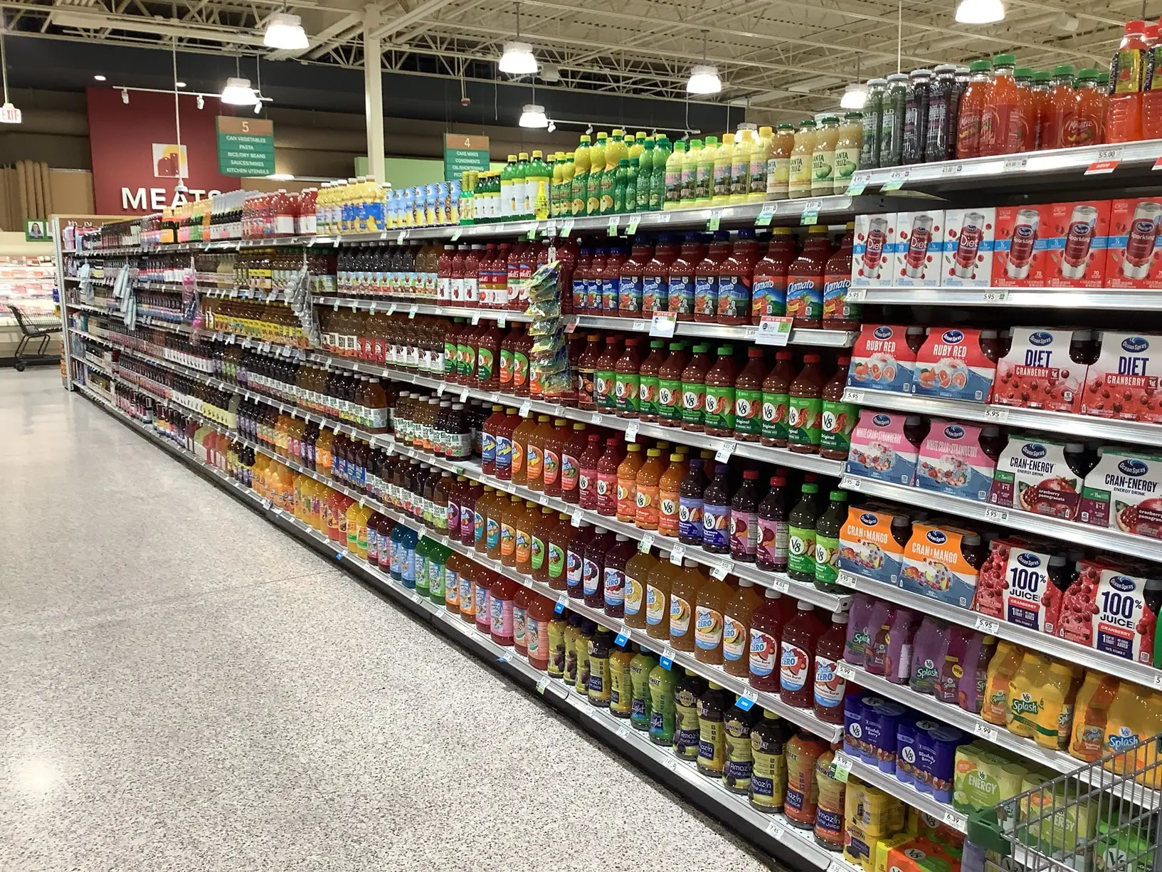 Grocery store shelf audit view of beverage category with organized products, pricing labels, and consistent planogram execution