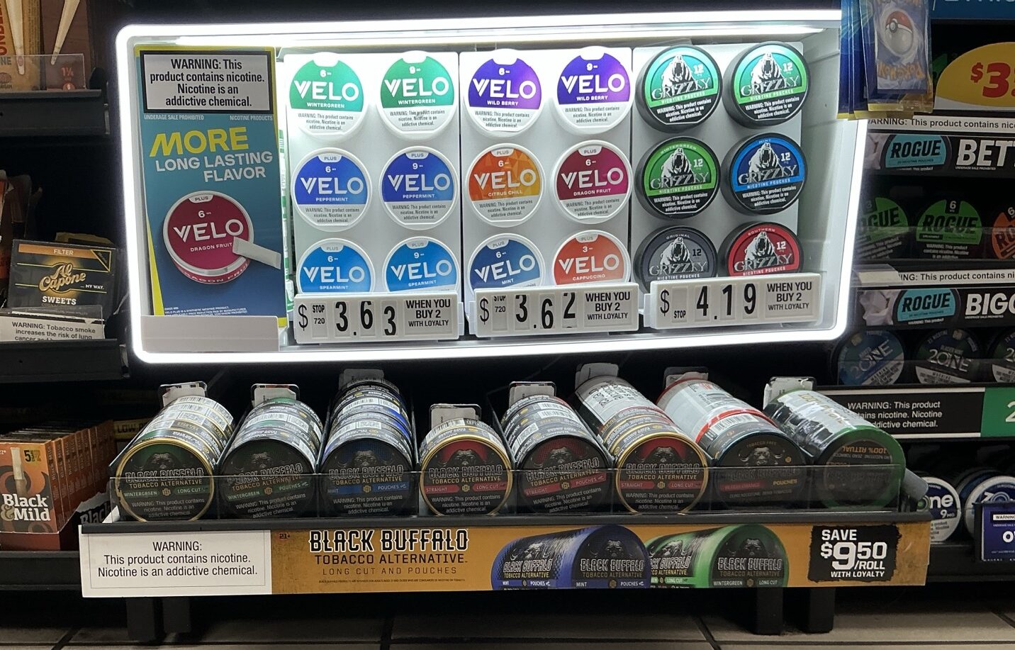 Convenience store shelf featuring smokeless tobacco products with branded point-of-sale materials installed to improve product visibility and in-store execution.